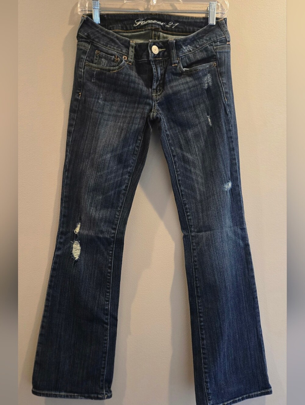 These are Forever 21 bootcut jeans featuring a distressed dark wash finish.